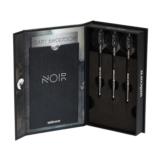 23831_Unicorn_Noir_Gary_Anderson_Phase_5_Softdarts_3 Die Abbildung zeigt ein Set der „Unicorn Noir Gary Anderson Phase 5 Softdarts“ in einer eleganten Box. Im rechten Teil der Schachtel sind drei schwarze Darts ordentlich nebeneinander platziert.