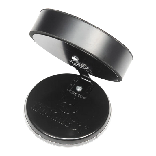 Das Bild zeigt das Produkt "Ruthless Mini Desktop Dartboard Set" in geöffnetem Zustand. Es besteht aus zwei runden, schwarzen Teilen, die durch ein Scharnier verbunden sind.